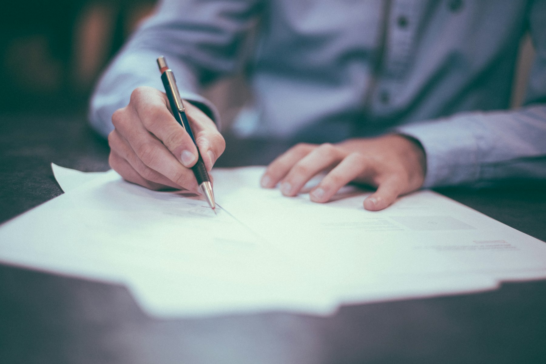 Signing tax documentation at a desk